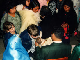 Adam Caddel kissing baby jesus christmas Eve in the Cathedral San Cristobal de las Casas, Chiapas Mexico Photography by Bill Bell