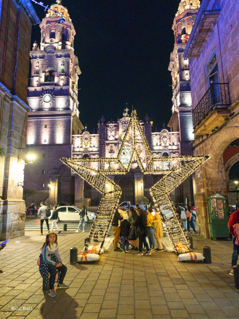 A glowing star-shaped decoration frames the stunning façade of Morelia Cathedral, capturing the festive atmosphere and architectural beauty of Mexico’s Christmas celebrations.