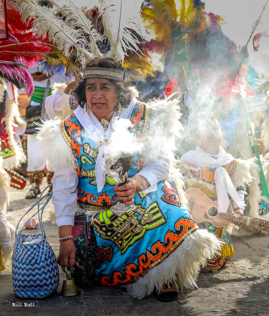 A woman kneels with incense during a celebration for Our Lady of Guadalupe, symbolizing devotion and prayer. The Feast of Our Lady of Guadalupe is a vibrant and spiritual kickoff to Mexico’s Christmas season, uniting faith and cultural heritage.