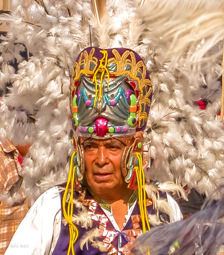 A devoted participant dressed in traditional Aztec-inspired attire honors Our Lady of Guadalupe during the December 12th celebrations. The event reflects the blending of indigenous and Catholic traditions that define this cherished Mexican holiday.